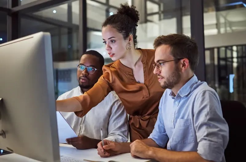 team-collaboration-reviewing-project-on-computer-2